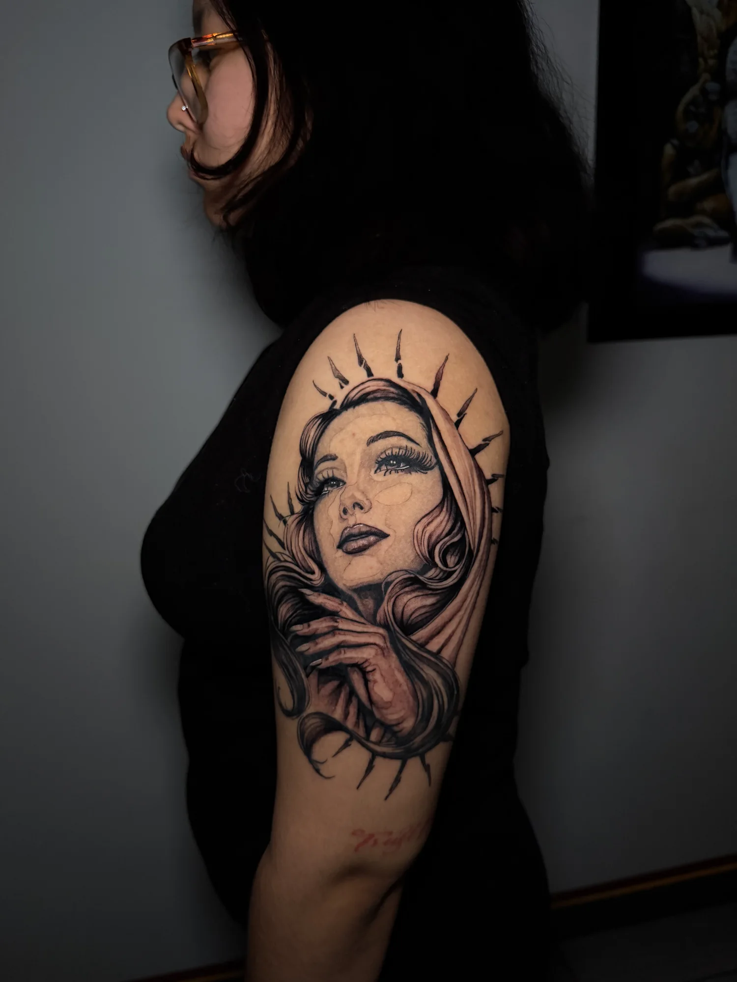 Large black and grey celestial woman portrait tattoo on the upper arm